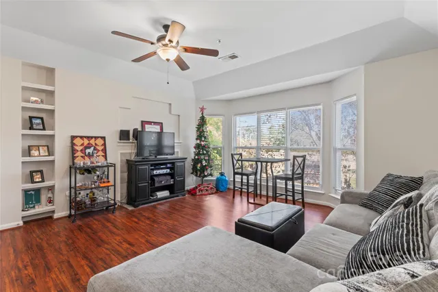 a living room with furniture and a wooden floor