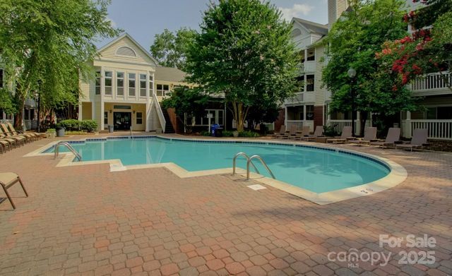 a view of a house with a yard and sitting area