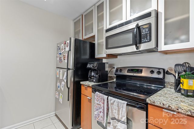 a kitchen with stainless steel appliances a stove and a microwave