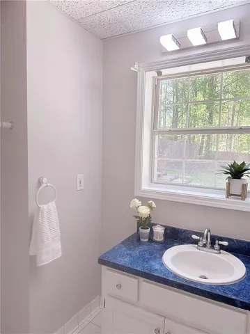 a bathroom with a granite countertop sink and a mirror