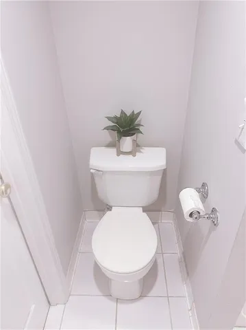 a white toilet sitting next to a white sink