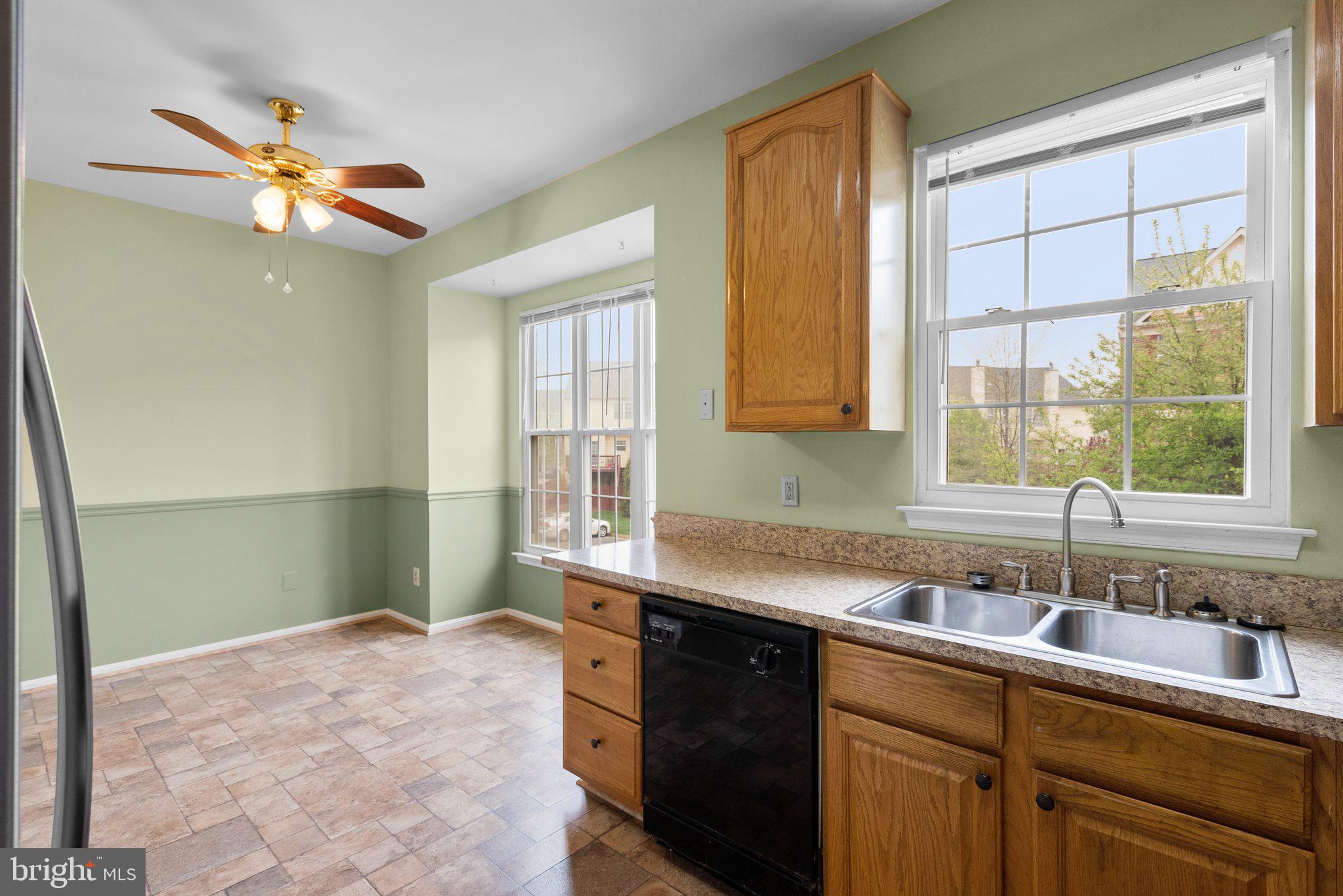21937 Thompson Square Sterling, VA 20166 - Photo 18 of 48 a kitchen with a sink cabinets and window
