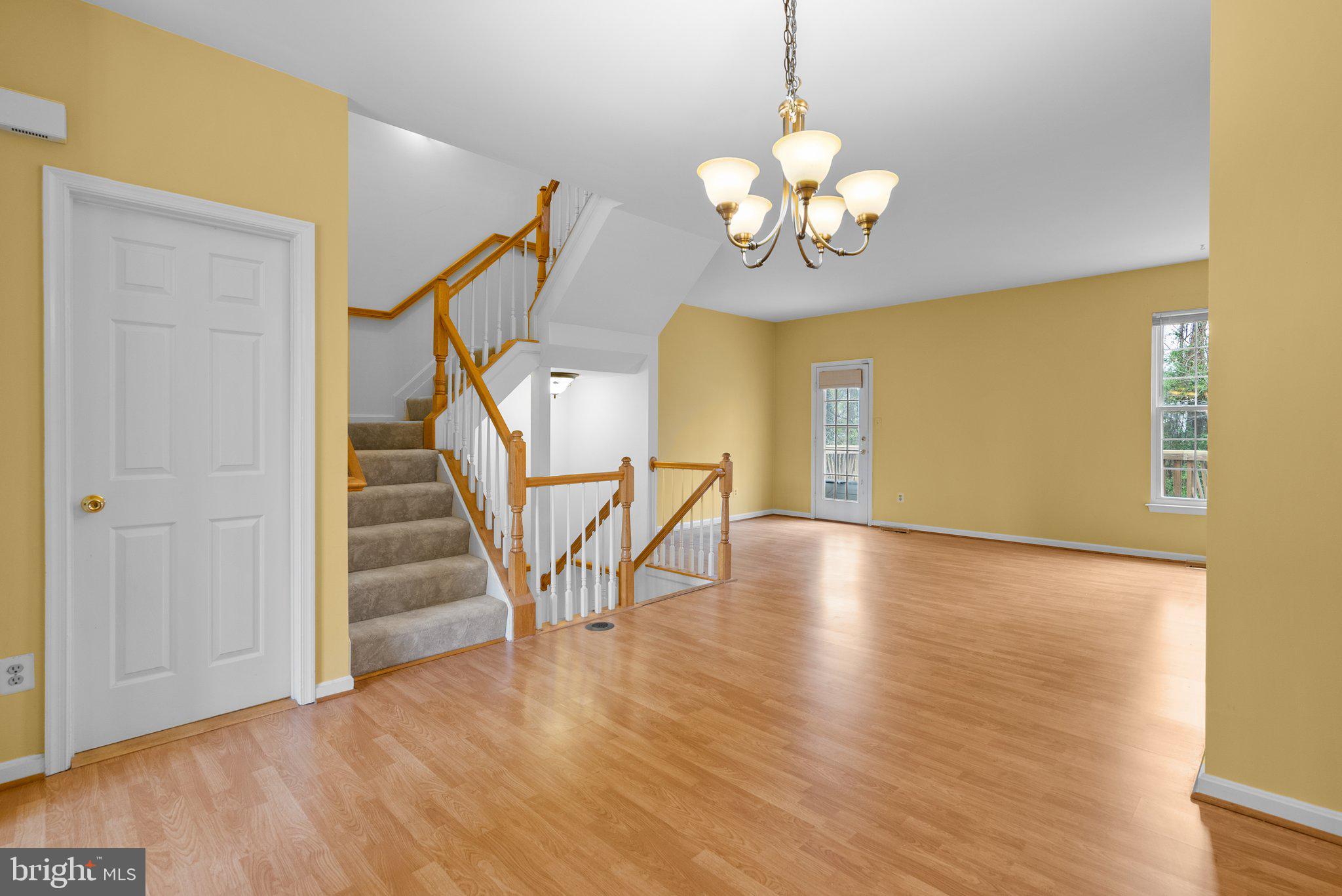 21937 Thompson Square Sterling, VA 20166 - Photo 22 of 48 a view of a livingroom with wooden floor and a chandelier