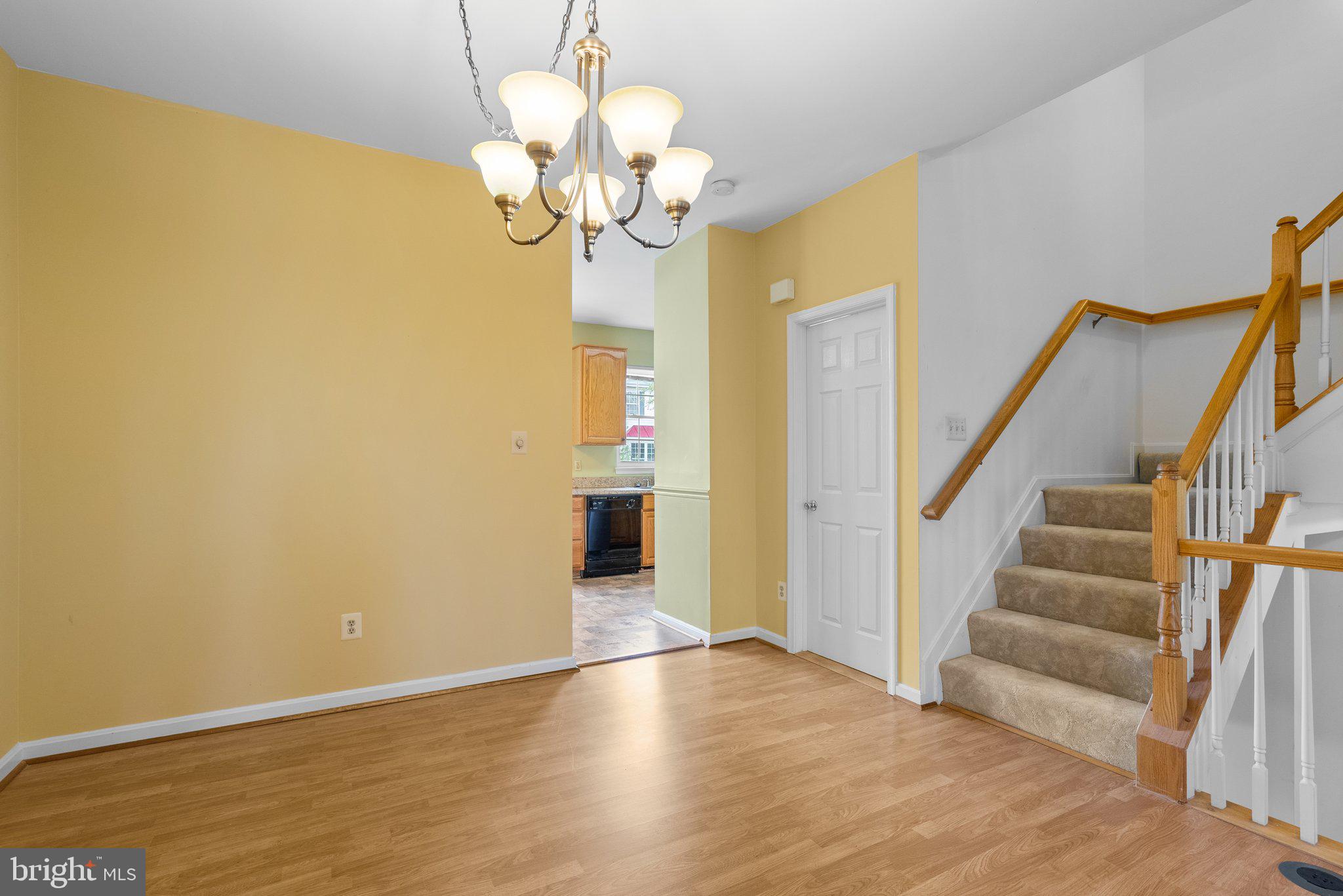21937 Thompson Square Sterling, VA 20166 - Photo 25 of 48 a view of a room with wooden floor and chandelier