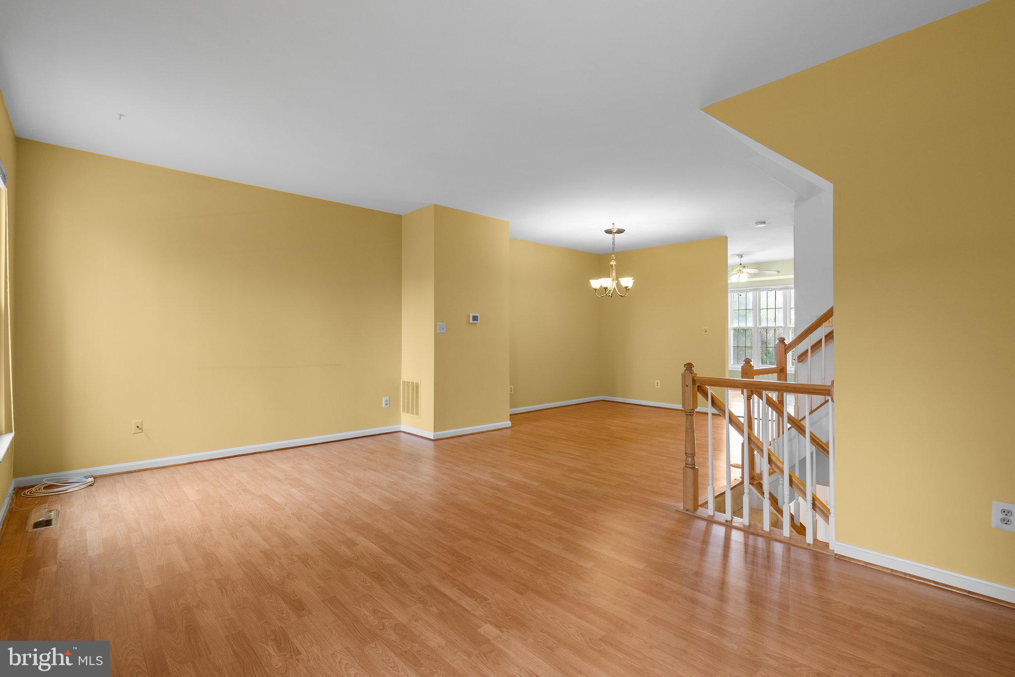 21937 Thompson Square Sterling, VA 20166 - Photo 27 of 48 a view of an empty room with wooden floor and a window