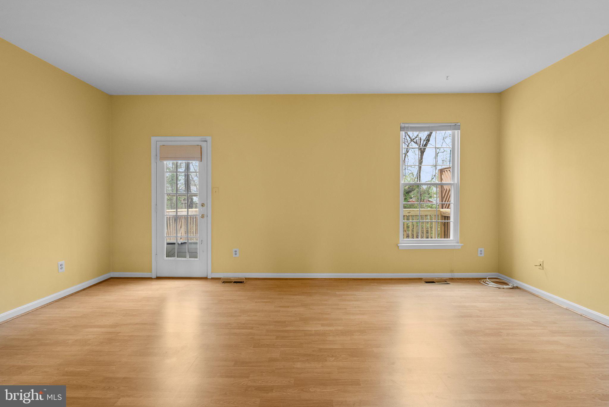 21937 Thompson Square Sterling, VA 20166 - Photo 29 of 48 a view of an empty room with wooden floor and a window
