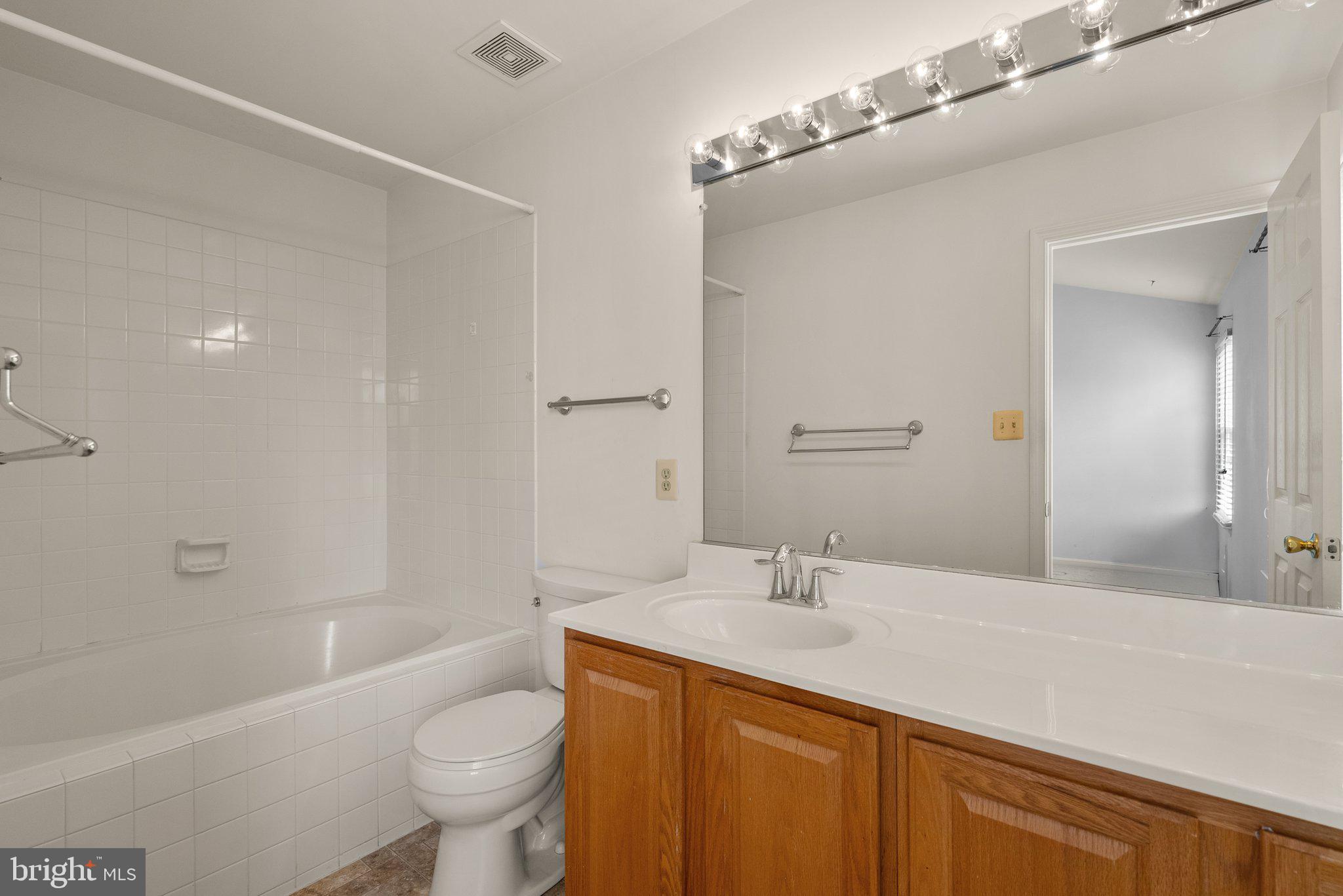 21937 Thompson Square Sterling, VA 20166 - Photo 35 of 48 a bathroom with a sink a toilet and shower