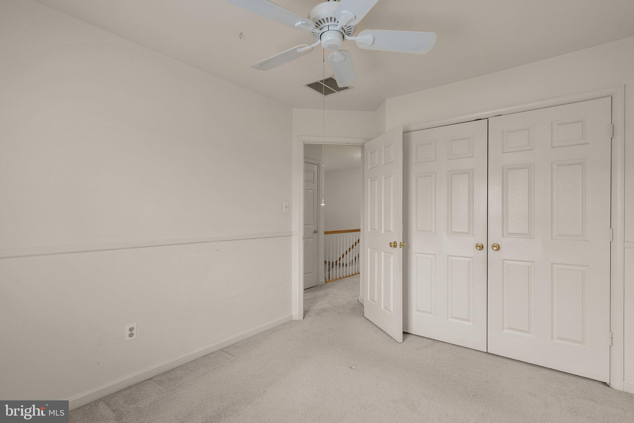 21937 Thompson Square Sterling, VA 20166 - Photo 37 of 48 an empty room with a ceiling fan and a bathroom
