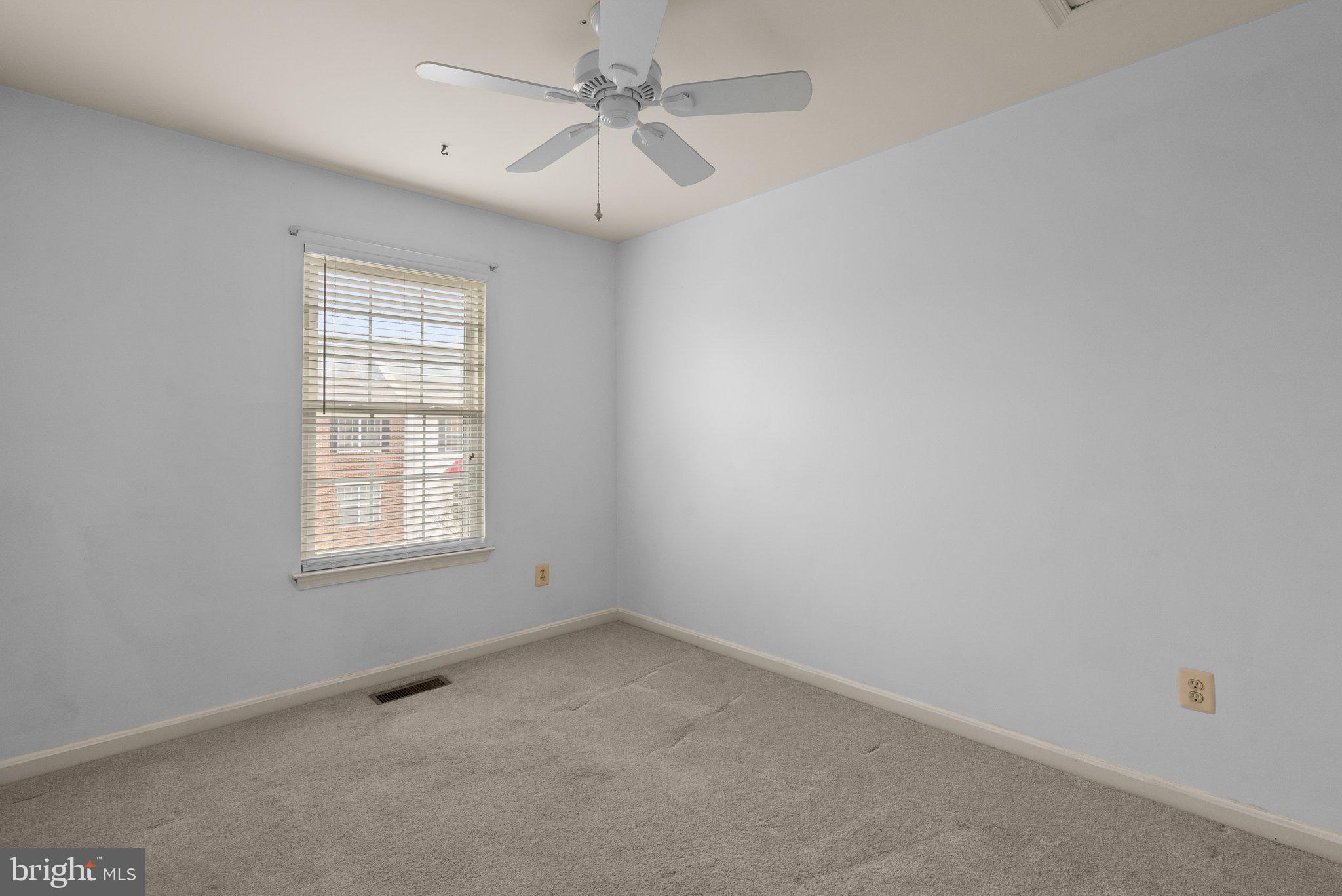 21937 Thompson Square Sterling, VA 20166 - Photo 40 of 48 an empty room with a window and a fan