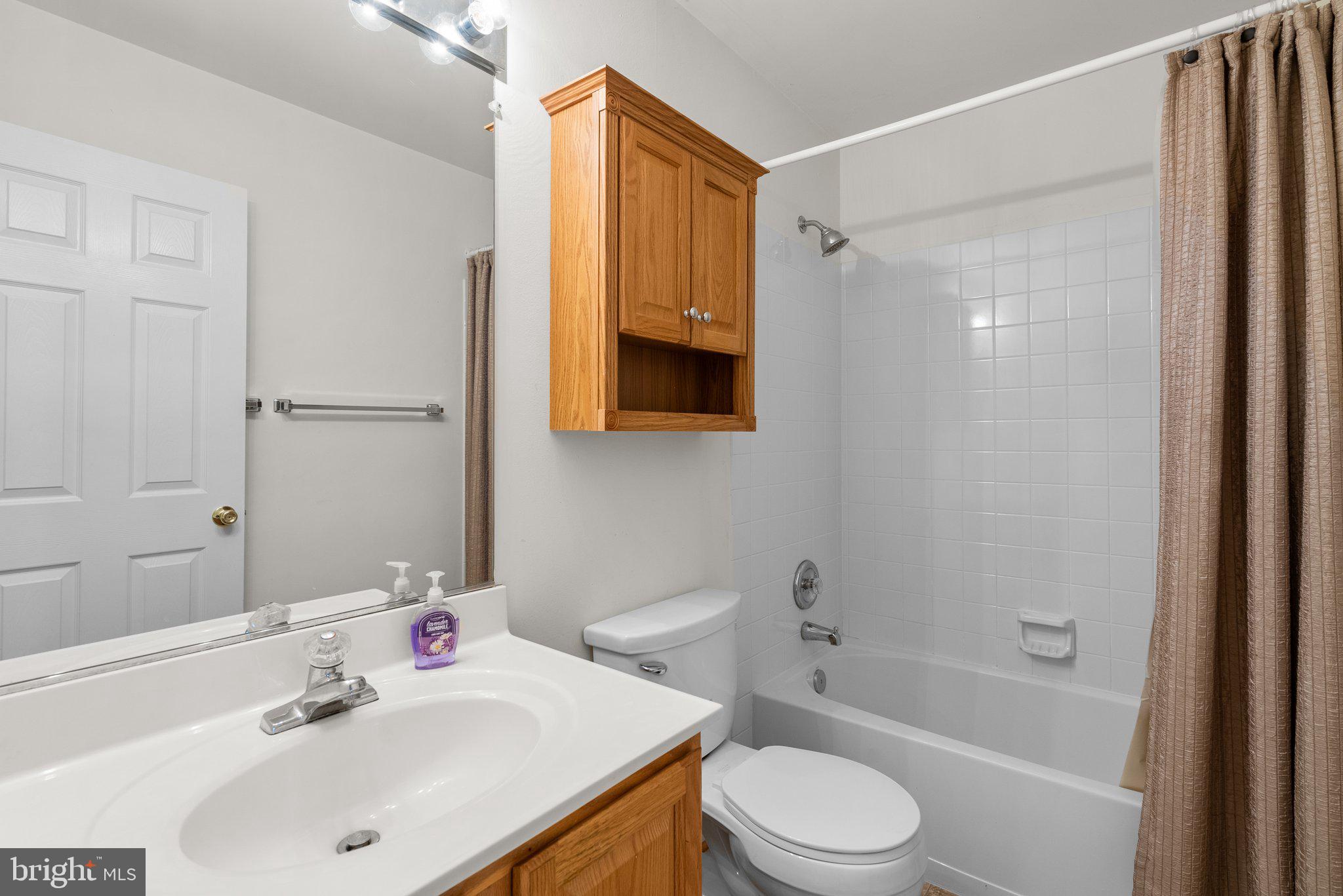 21937 Thompson Square Sterling, VA 20166 - Photo 41 of 48 a bathroom with a sink toilet and shower