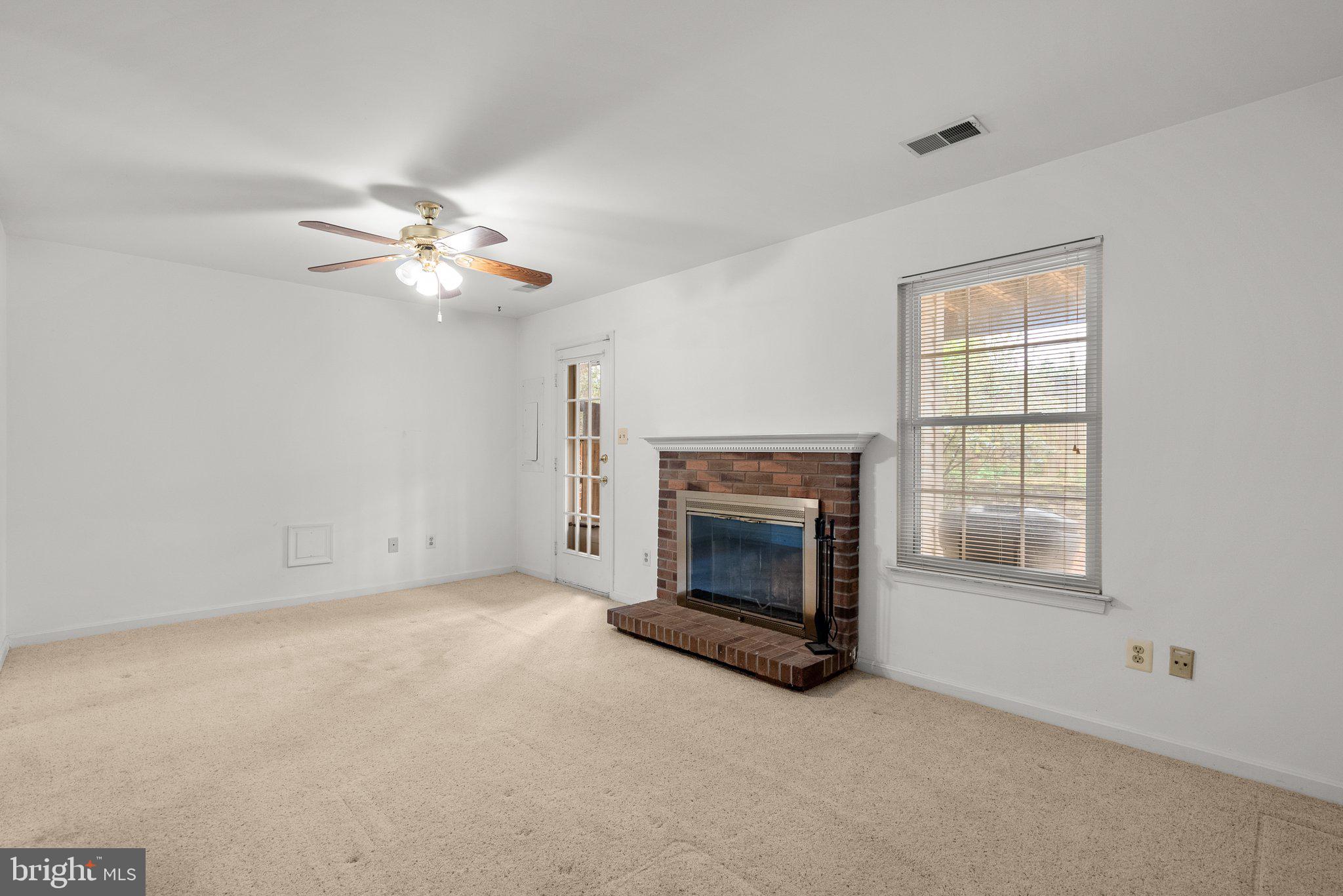 21937 Thompson Square Sterling, VA 20166 - Photo 5 of 48 an empty room with fireplace fan and windows