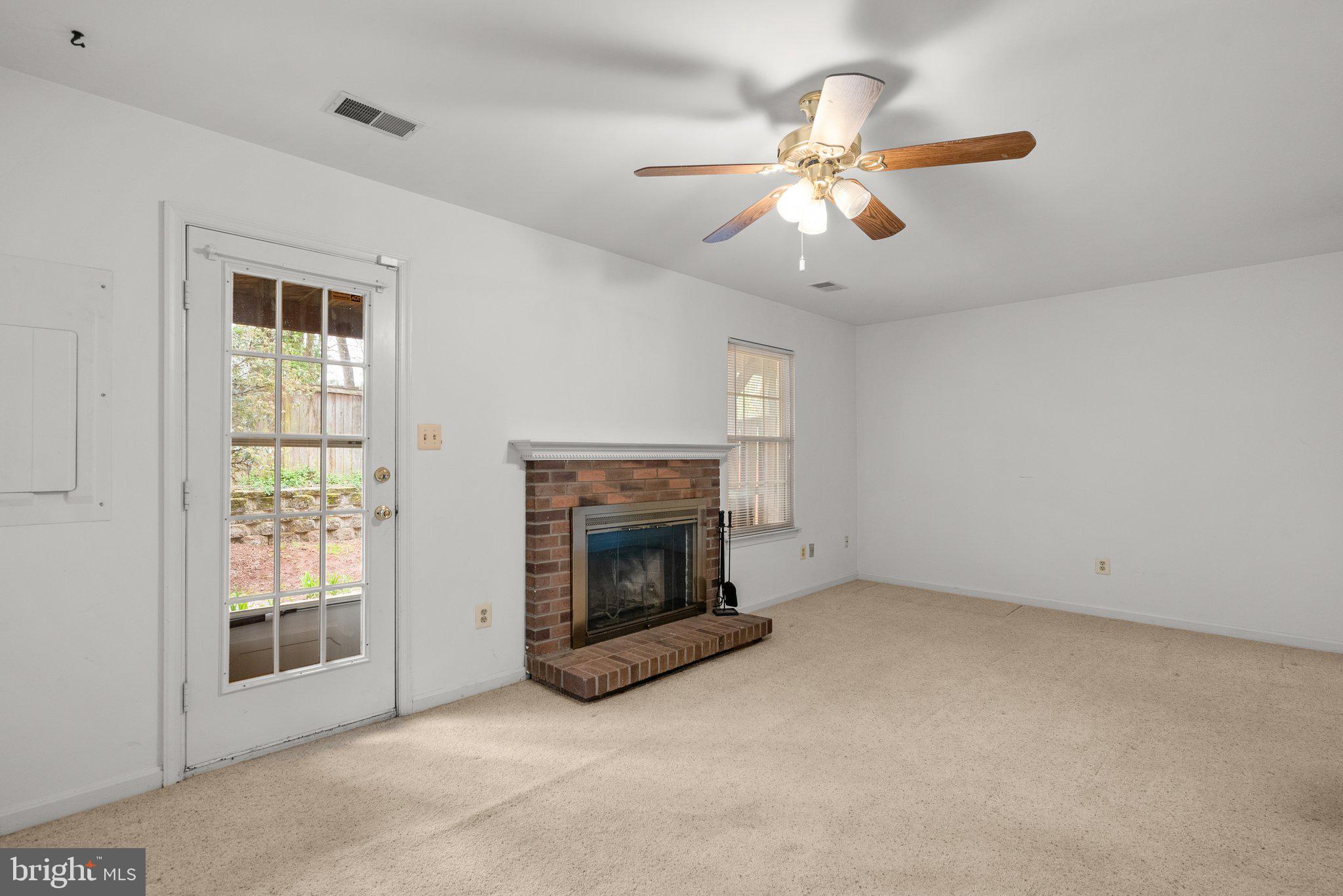 21937 Thompson Square Sterling, VA 20166 - Photo 6 of 48 an empty room with chandelier fan and windows