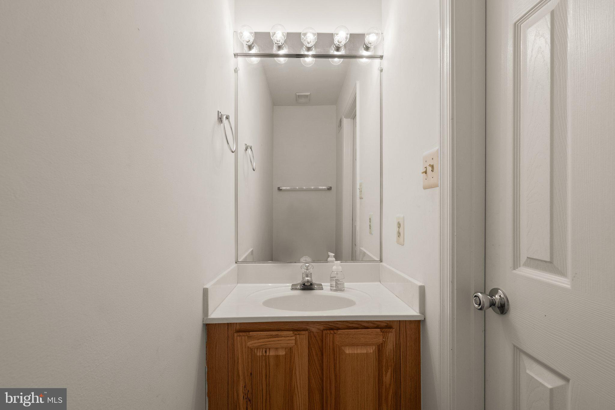 21937 Thompson Square Sterling, VA 20166 - Photo 10 of 48 a bathroom with a granite countertop sink and a mirror