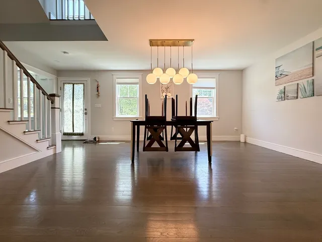 a view of a livingroom with furniture wooden floor and chandelier