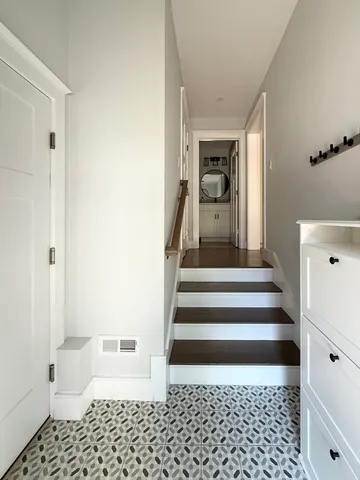 a view of a hallway with a white walls and stairs