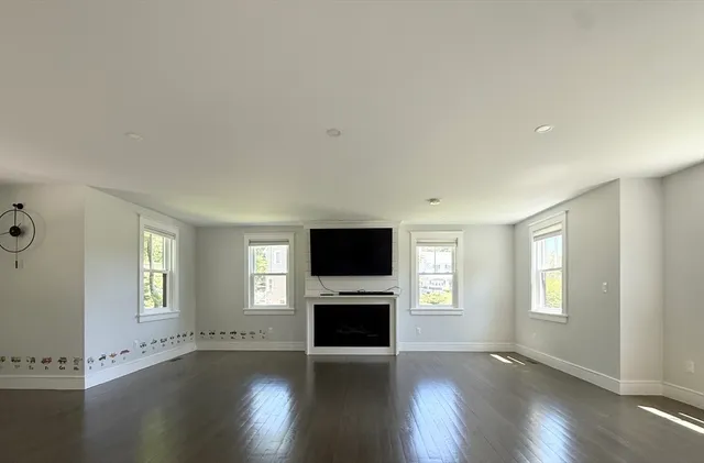 an empty room with chair and windows