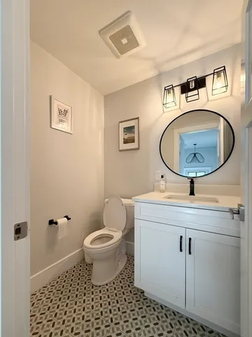 a bathroom with a sink a toilet and a mirror