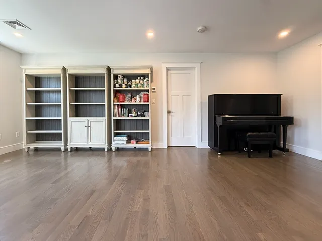 a view of room with furniture and wooden floor