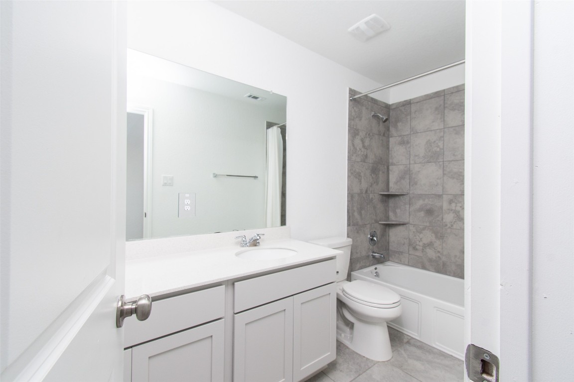 9101 Daisy Cutter Crossing Georgetown, TX 78626 - Photo 15 of 28 Full bath with vanity, tub / shower combination, and tile patterned floors