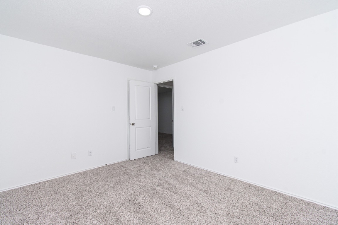 9101 Daisy Cutter Crossing Georgetown, TX 78626 - Photo 16 of 28 Unfurnished room featuring light carpet and baseboards