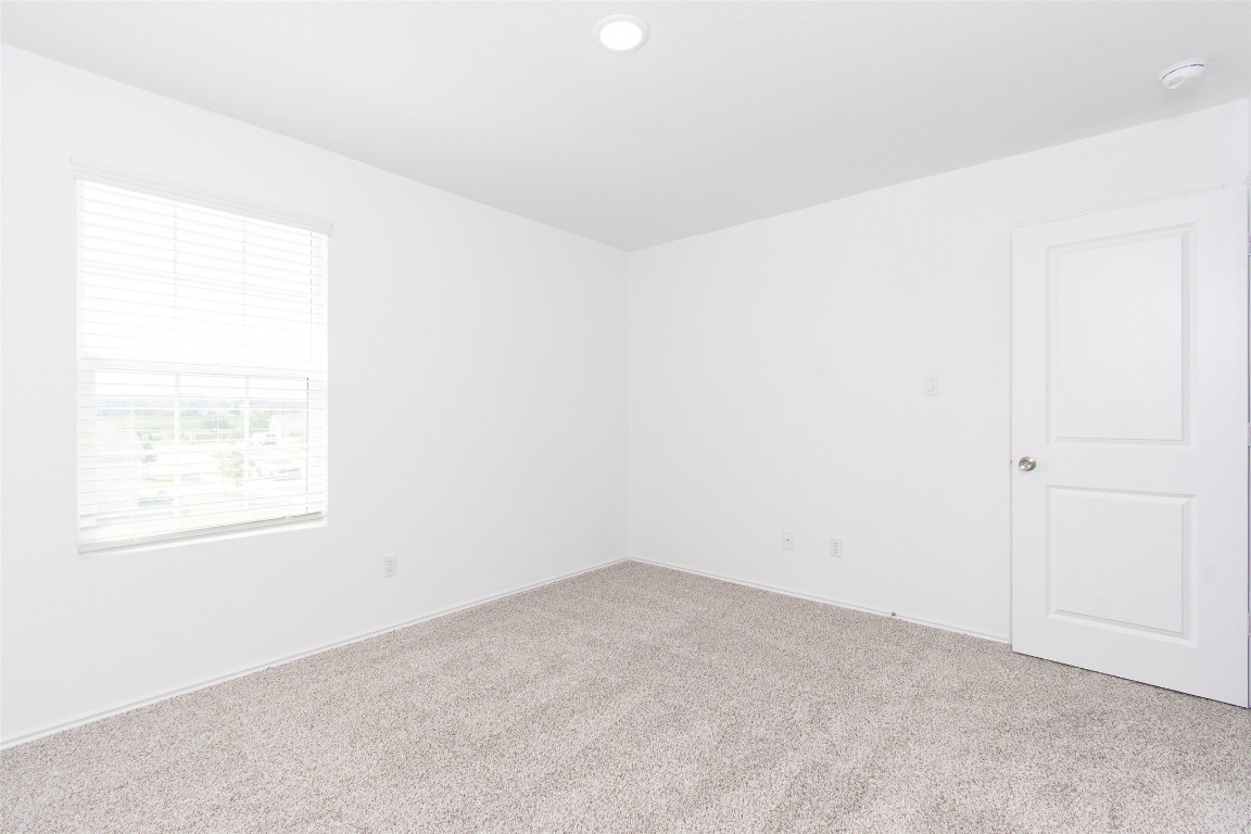 9101 Daisy Cutter Crossing Georgetown, TX 78626 - Photo 17 of 28 Unfurnished room featuring carpet flooring, a smoke detector, and recessed lighting