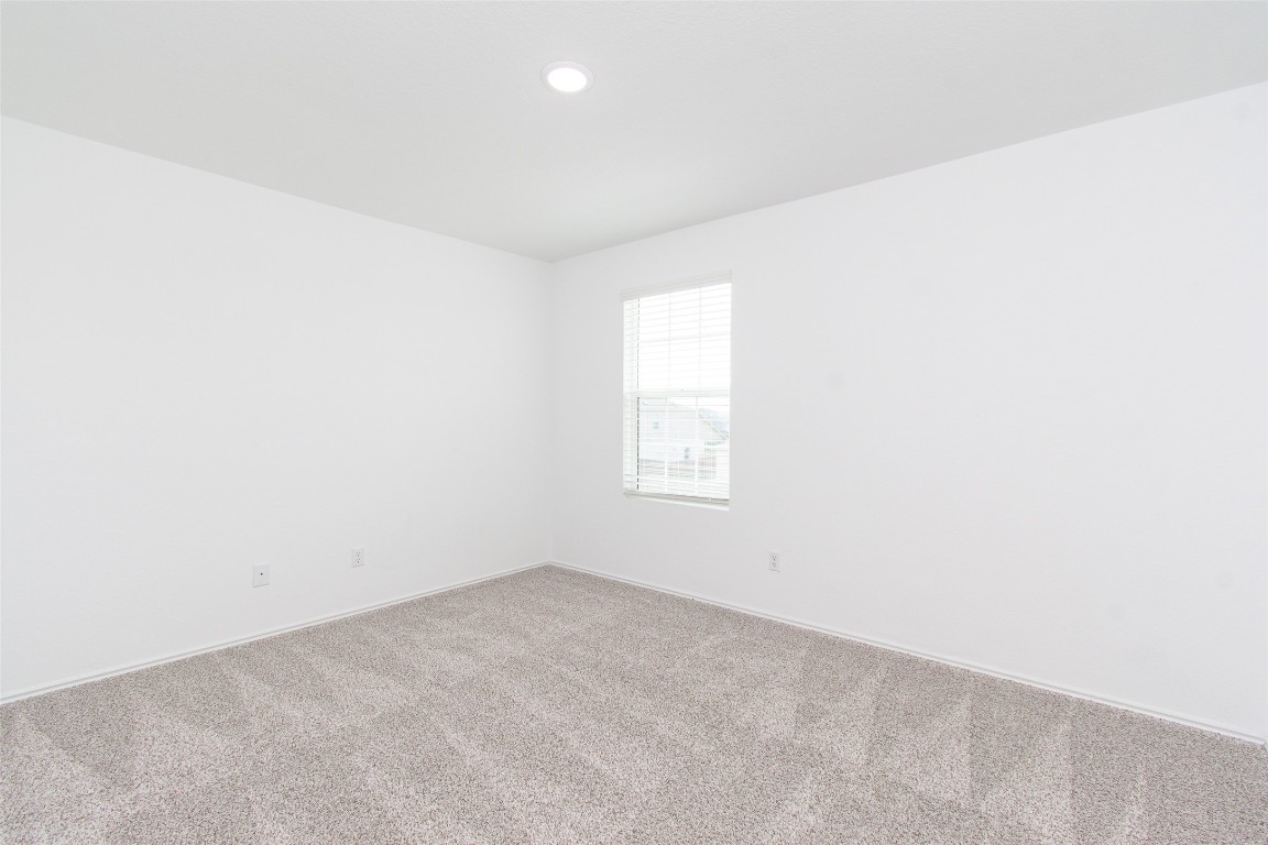 9101 Daisy Cutter Crossing Georgetown, TX 78626 - Photo 18 of 28 Carpeted spare room featuring baseboards and recessed lighting
