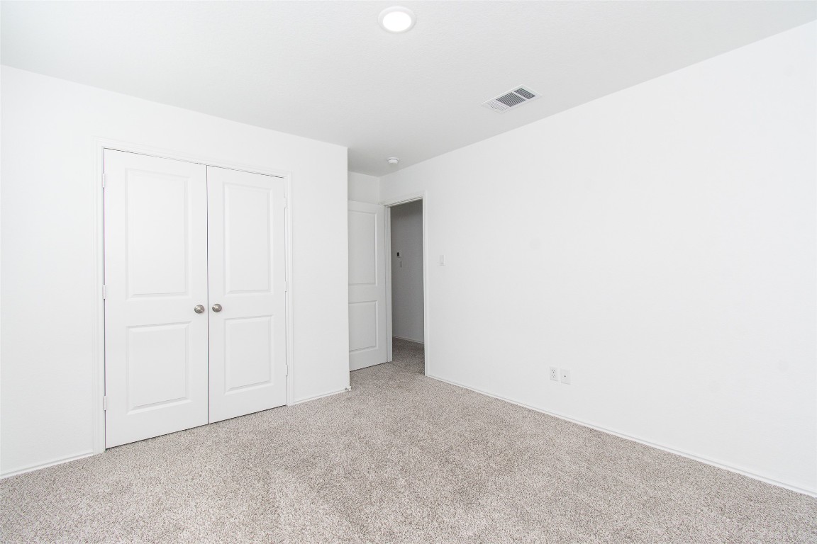 9101 Daisy Cutter Crossing Georgetown, TX 78626 - Photo 19 of 28 Unfurnished bedroom featuring carpet floors and a closet