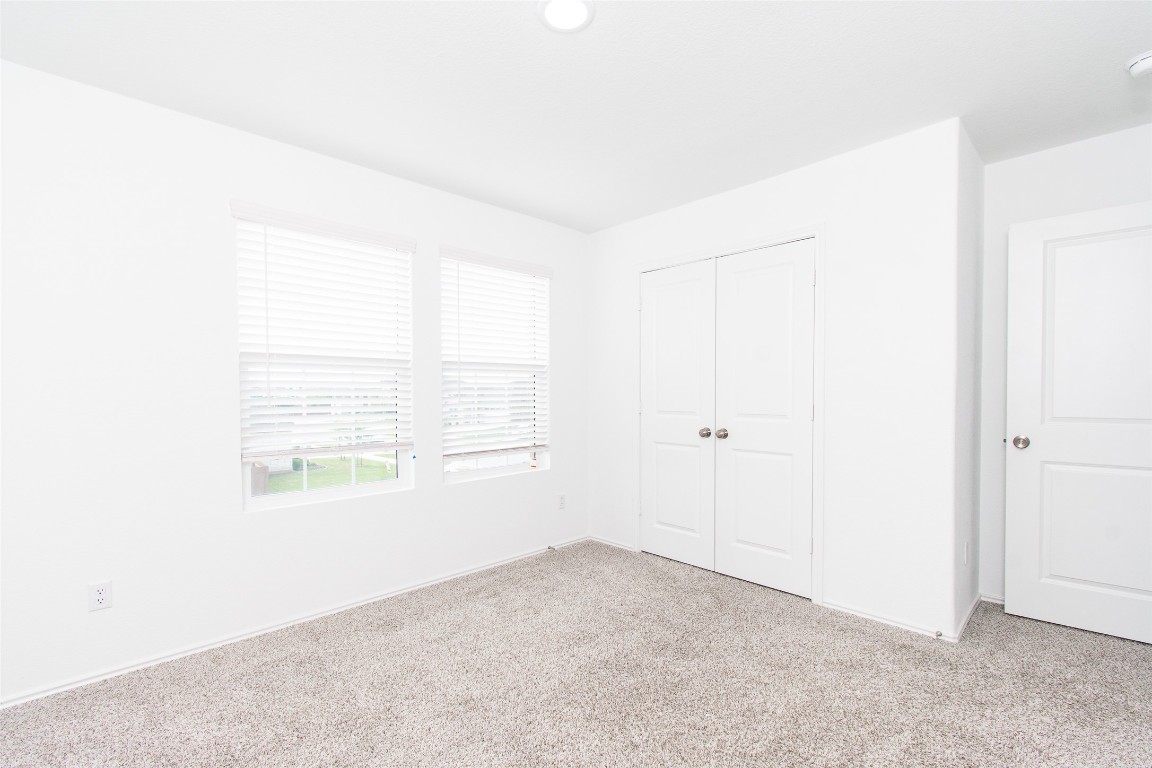 9101 Daisy Cutter Crossing Georgetown, TX 78626 - Photo 20 of 28 Unfurnished bedroom with carpet flooring and a closet