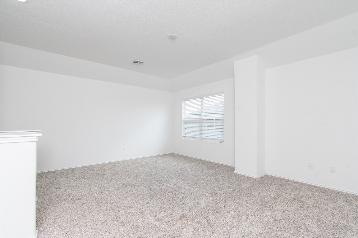 9101 Daisy Cutter Crossing Georgetown, TX 78626 - Photo 21 of 28 Empty room featuring light colored carpet and baseboards