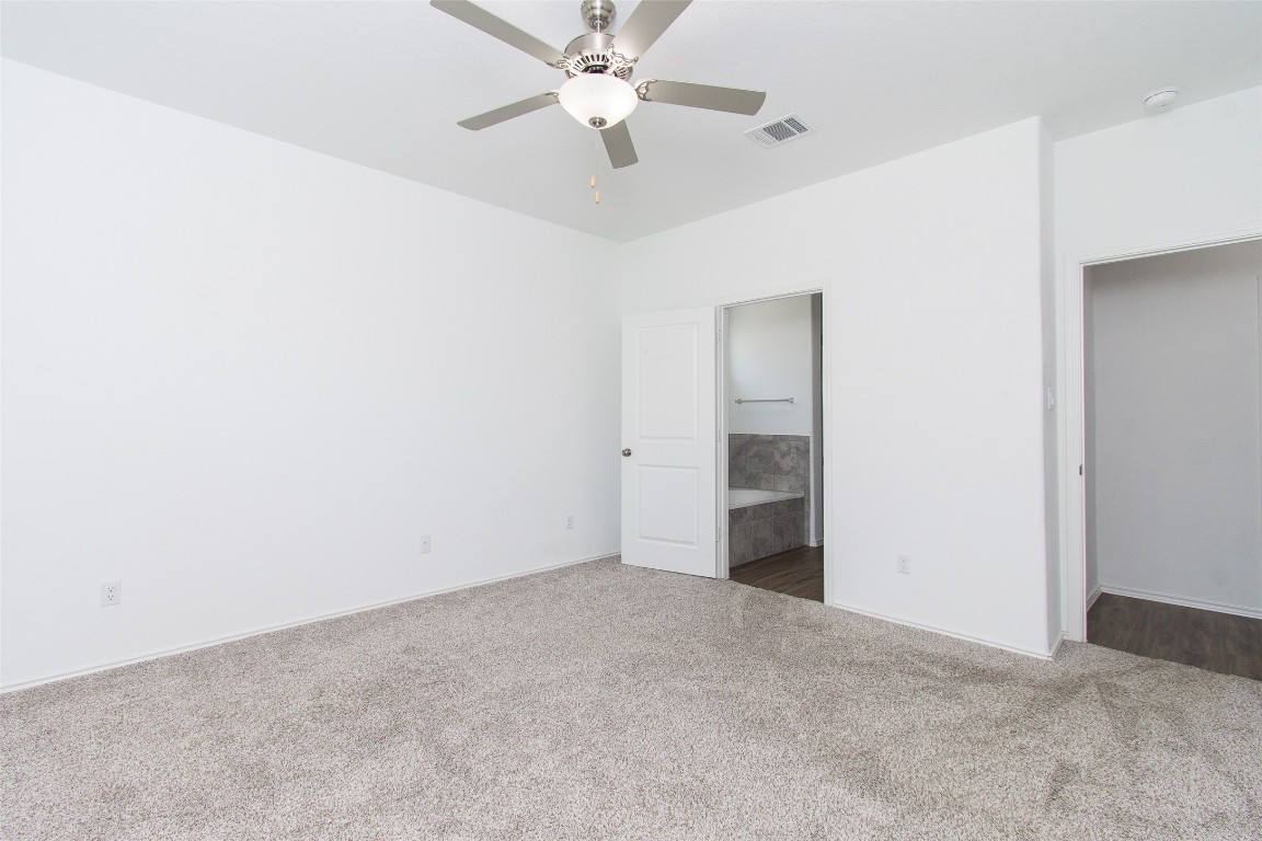 9101 Daisy Cutter Crossing Georgetown, TX 78626 - Photo 25 of 28 Unfurnished bedroom with carpet floors, ensuite bathroom, and ceiling fan