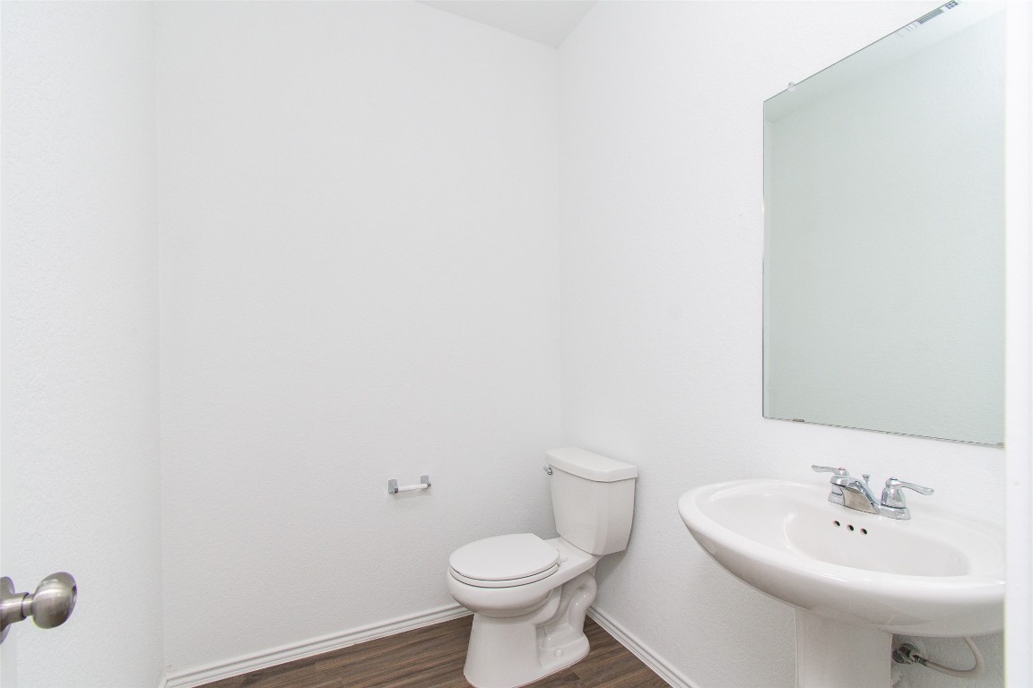 9101 Daisy Cutter Crossing Georgetown, TX 78626 - Photo 27 of 28 Half bath with wood finished floors and toilet