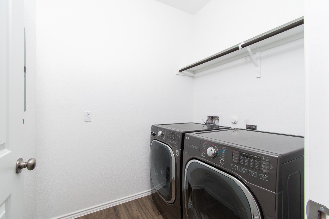9101 Daisy Cutter Crossing Georgetown, TX 78626 - Photo 6 of 28 Laundry room featuring washing machine and dryer and dark wood-type flooring