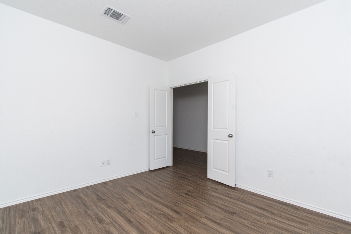 9101 Daisy Cutter Crossing Georgetown, TX 78626 - Photo 7 of 28 Empty room featuring dark wood finished floors and baseboards