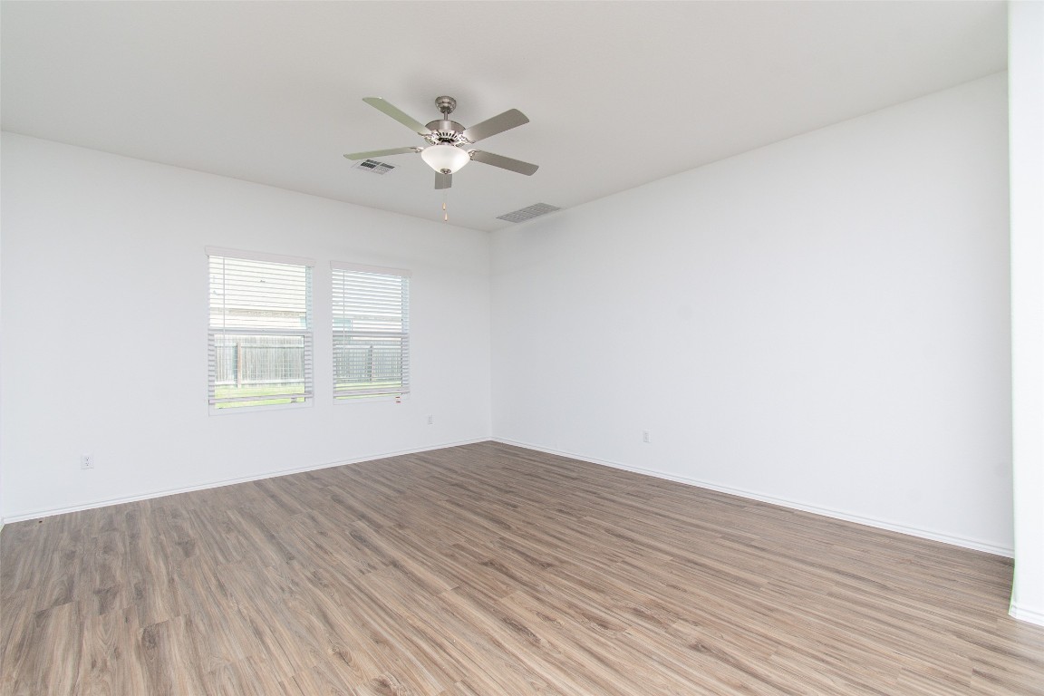 9101 Daisy Cutter Crossing Georgetown, TX 78626 - Photo 10 of 28 Empty room with light wood-style flooring and ceiling fan