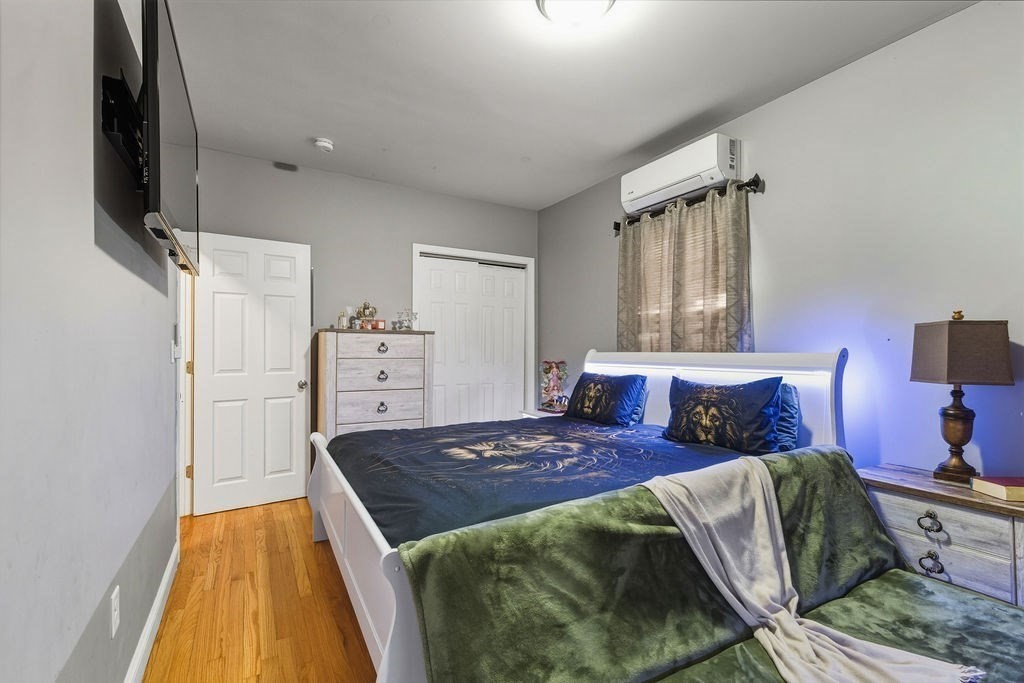 271 Mulberry Street Fall River, MA 02721 - Photo 13 of 30 a spacious bedroom with a bed and wooden floor