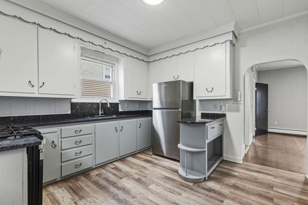 271 Mulberry Street Fall River, MA 02721 - Photo 16 of 30 a kitchen with a refrigerator and white cabinets