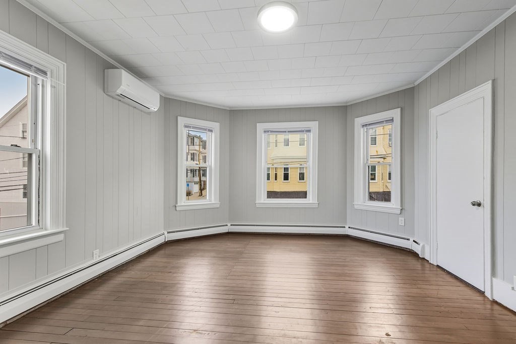 271 Mulberry Street Fall River, MA 02721 - Photo 20 of 30 an empty room with wooden floor and windows