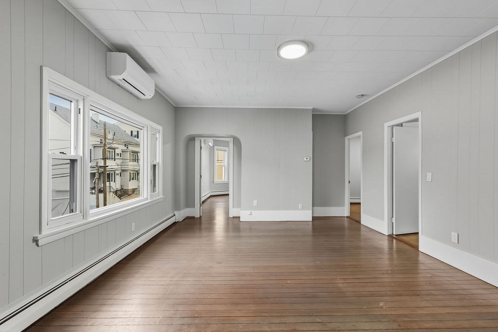 271 Mulberry Street Fall River, MA 02721 - Photo 22 of 30 a view of an empty room with wooden floor and a window