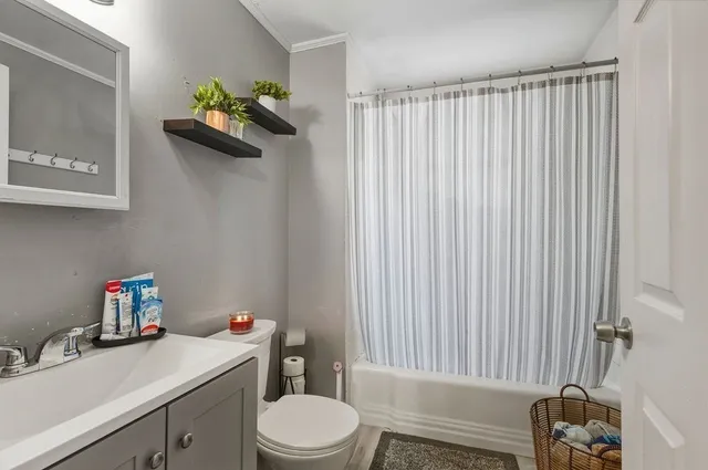 a bathroom with a sink toilet and a mirror