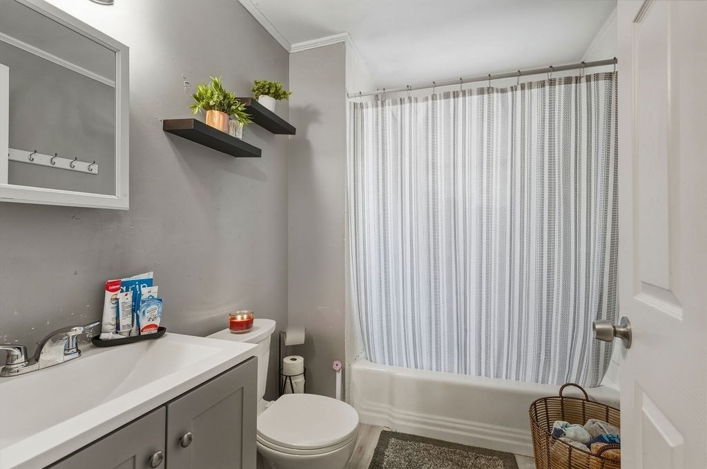 271 Mulberry Street Fall River, MA 02721 - Photo 9 of 30 a bathroom with a sink vanity mirror and toilet