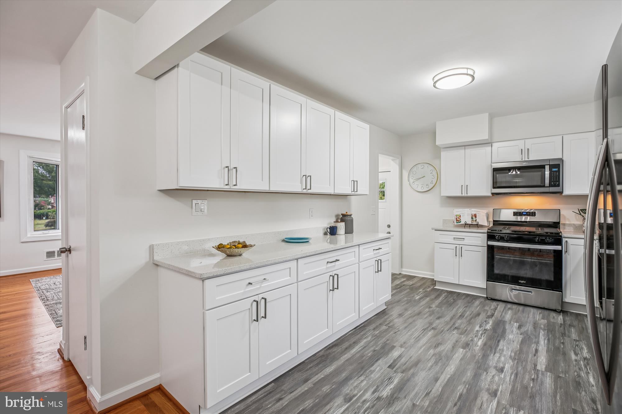 11502 Nairn Road Silver Spring, MD 20902 - Photo 13 of 43 a kitchen with stainless steel appliances granite countertop a stove top oven a sink dishwasher and a refrigerator with wooden floor