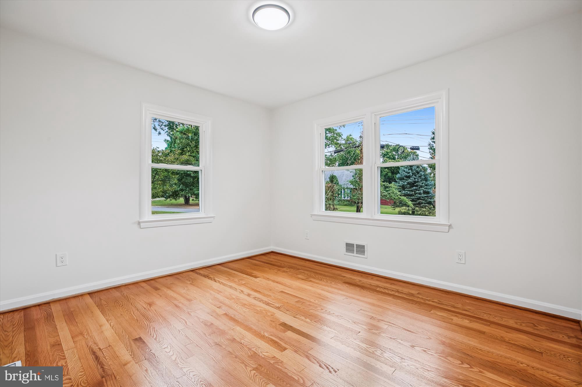 11502 Nairn Road Silver Spring, MD 20902 - Photo 20 of 43 an empty room with wooden floor and windows