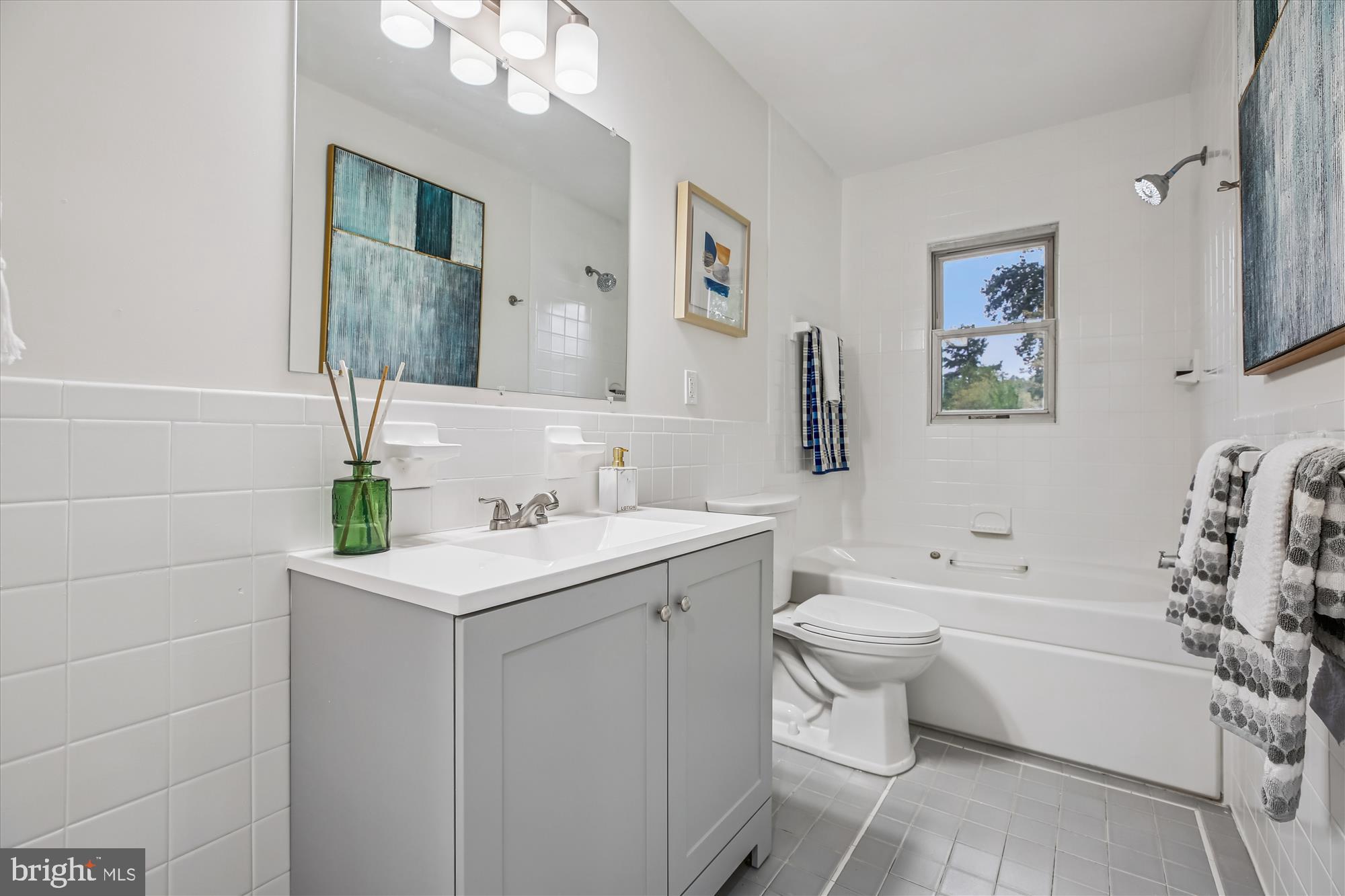 11502 Nairn Road Silver Spring, MD 20902 - Photo 22 of 43 a bathroom with a toilet a sink a tub and mirror