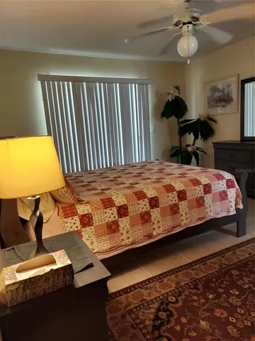 a bedroom with a bed and a potted plant