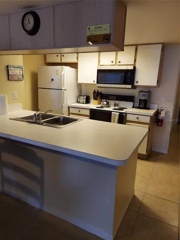 a kitchen with stainless steel appliances a stove a sink a stove and a microwave