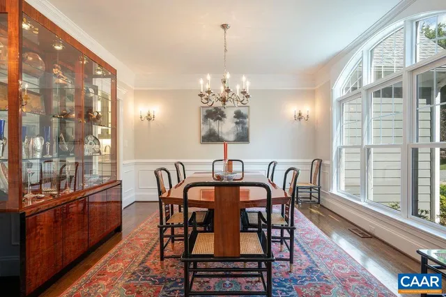 a large white bed sitting in a bedroom next to a window