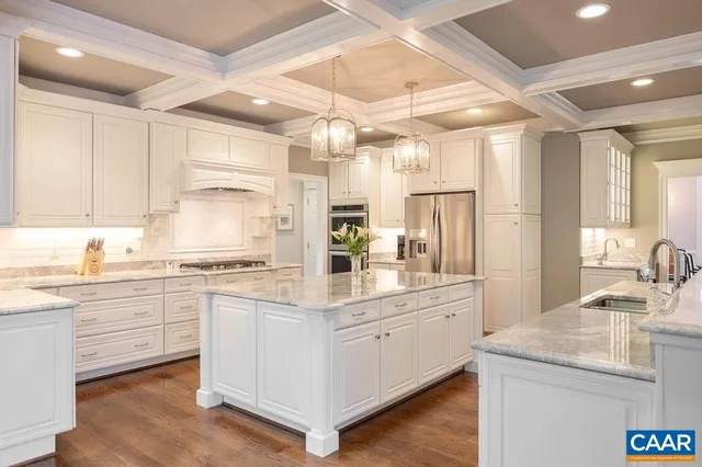 a kitchen with stainless steel appliances granite countertop a stove a sink dishwasher and a refrigerator