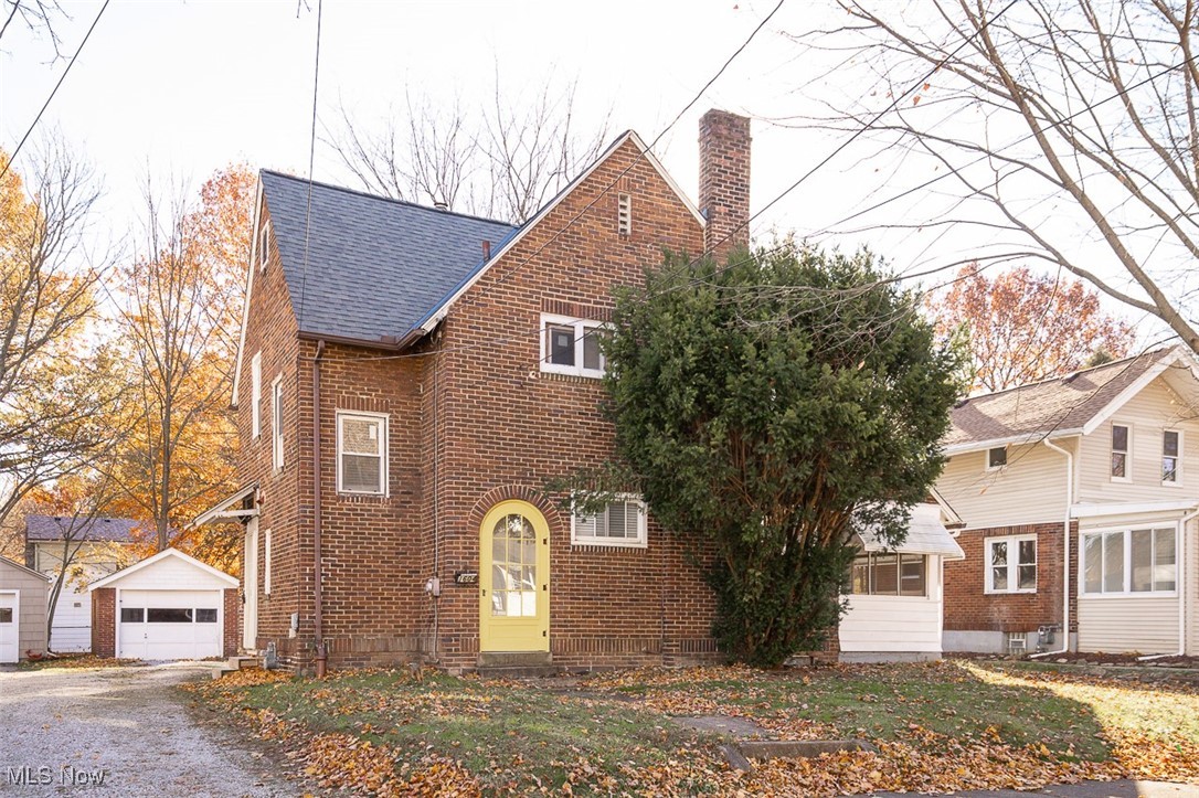 1604 Hampton Road Akron, OH 44305 - Photo 2 of 30 View of front facade featuring an outbuilding, a chimney, a detached garage, and brick siding
