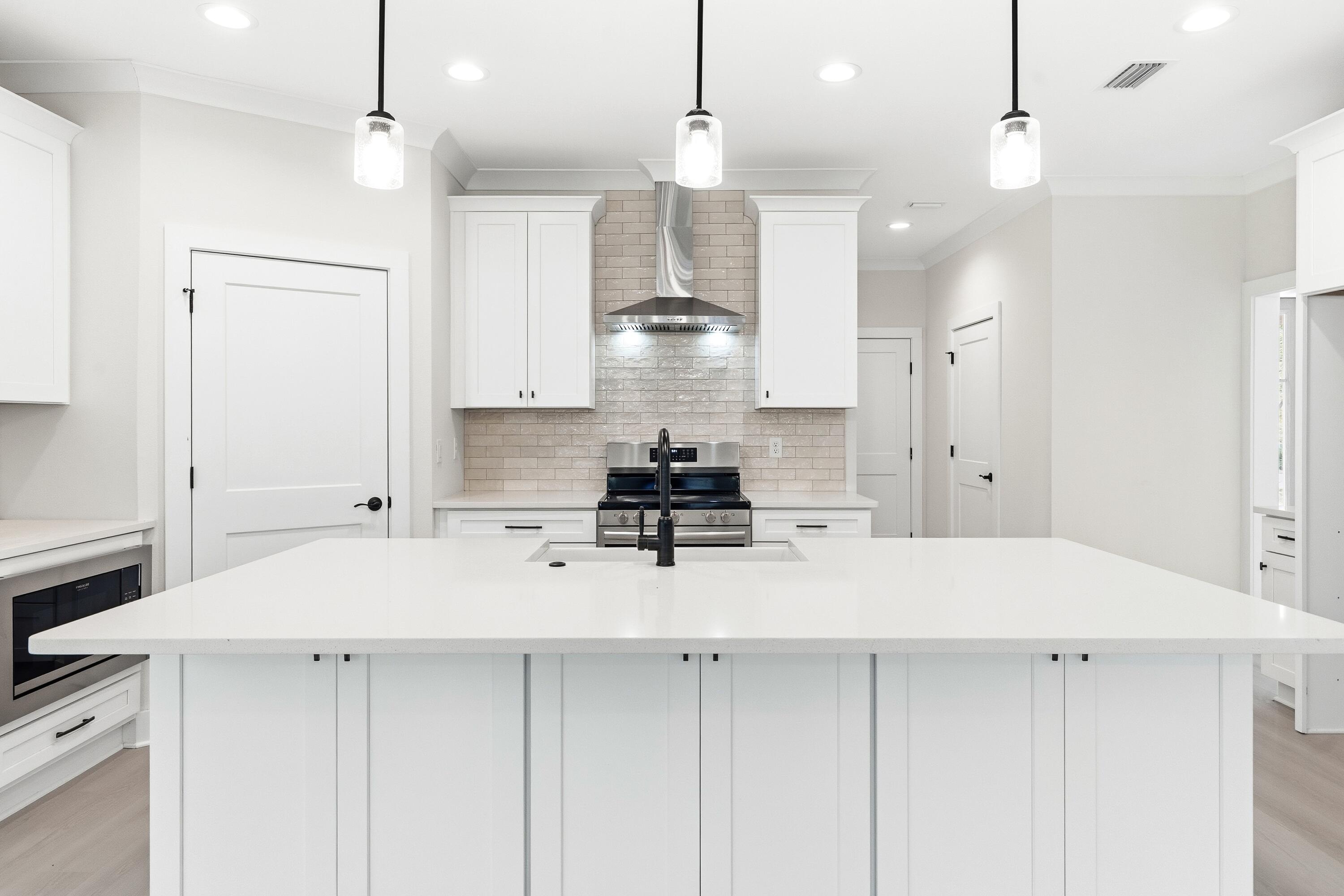 151 Redfish Pt Drive Freeport, FL 32439 - Photo 13 of 40 a kitchen with a sink refrigerator and white cabinets