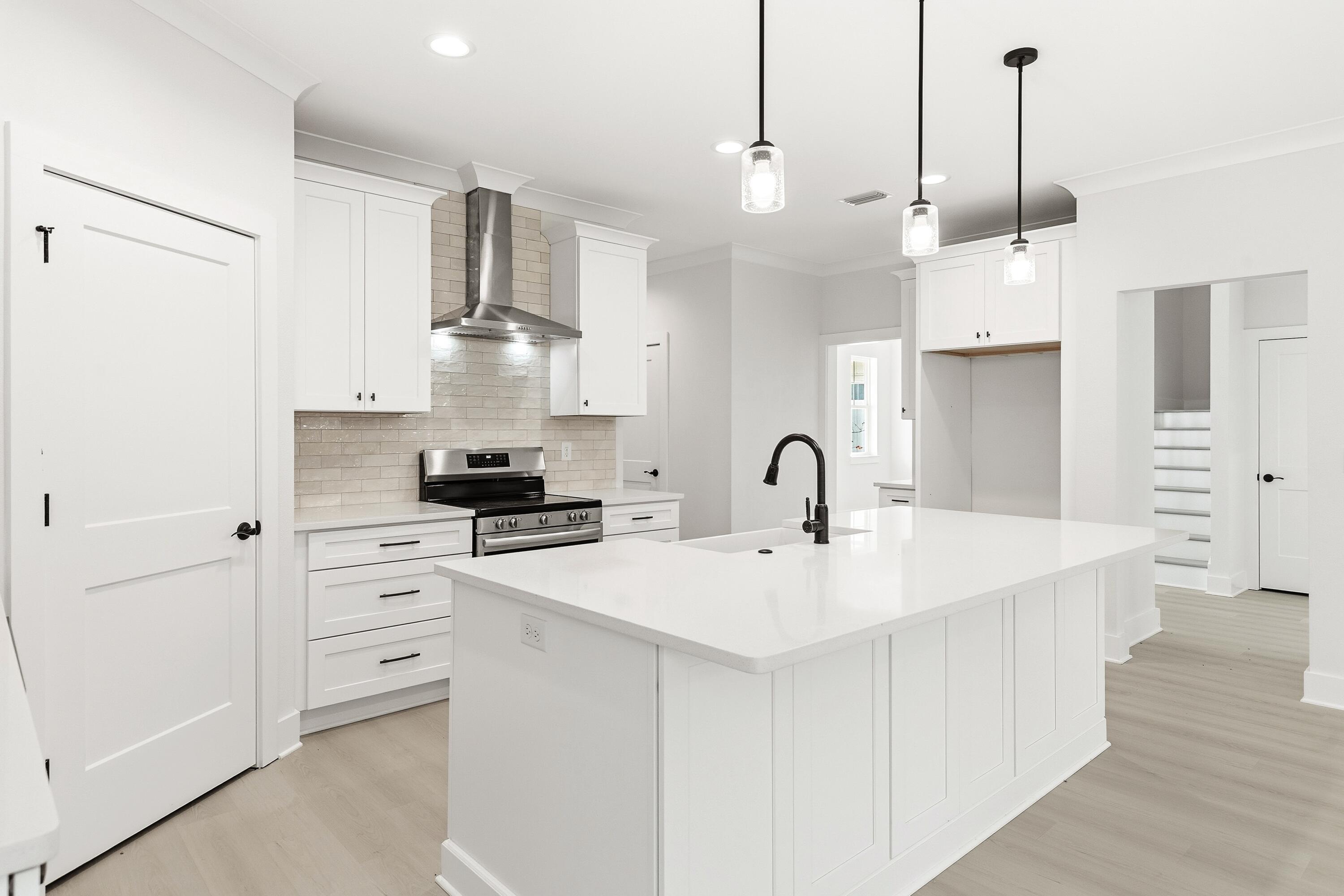 151 Redfish Pt Drive Freeport, FL 32439 - Photo 14 of 40 a kitchen with white cabinets and stainless steel appliances